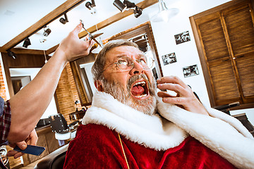 Image showing Santa claus shaving his personal barber