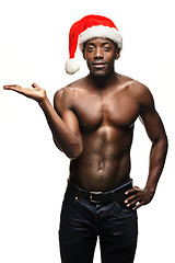 Image showing Muscular black shirtless young man in Santa Claus hat