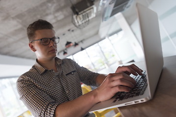 Image showing young  man working on laptop