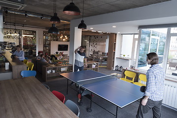 Image showing playing ping pong tennis at creative office space