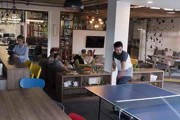 Image showing playing ping pong tennis at creative office space