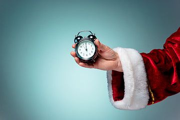 Image showing Santa holding an old alarm clock