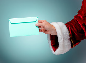 Image showing Hand in costume Santa Claus is holding the envelope