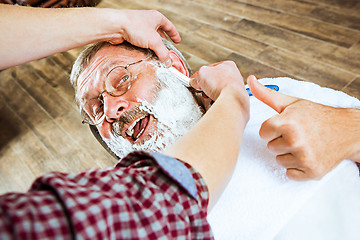 Image showing The senior man visiting hairstylist in barber shop.