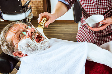 Image showing The senior man visiting hairstylist in barber shop.