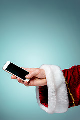 Image showing Santa Claus holding mobile smartphone ready for Christmas time