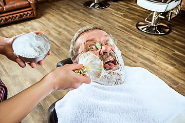 Image showing The senior man visiting hairstylist in barber shop.