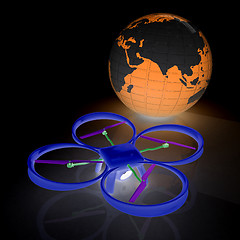 Image showing Quadrocopter Drone with Earth Globe and remote controller on a w