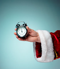 Image showing Santa holding an old alarm clock