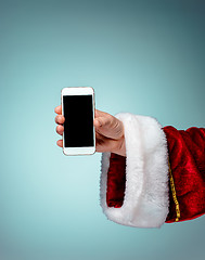 Image showing Santa Claus holding mobile smartphone ready for Christmas time