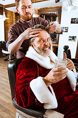 Image showing Santa claus shaving his personal barber