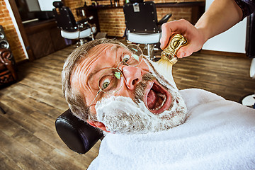 Image showing The senior man visiting hairstylist in barber shop.