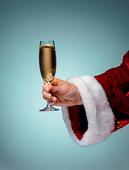 Image showing Santa Holding Champagne wineglass over blue