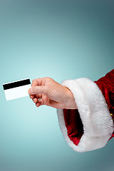 Image showing Santa Claus hand holding a credit card