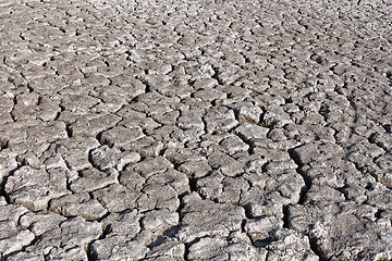 Image showing Cracked grey soil surface of dried pond