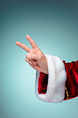 Image showing Santa Claus hand showing sign victory with thumbs up