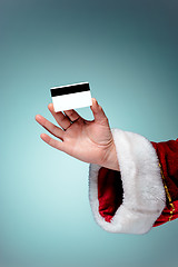 Image showing Santa Claus hand holding a credit card