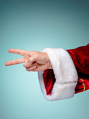 Image showing Santa Claus hand showing sign victory with thumbs up