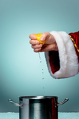 Image showing Photo of Santa Claus hand squeezing lemon