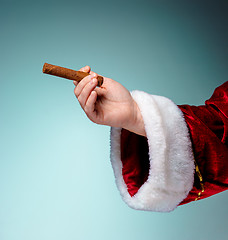 Image showing Photo of Santa Claus hand with a cigar