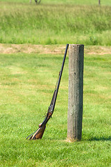 Image showing Rifle on a green meadow
