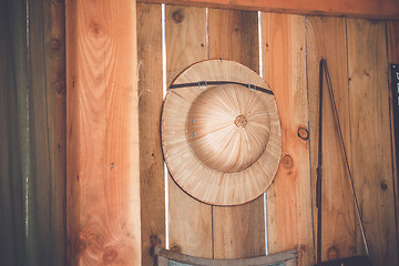 Image showing Tropical hat hanging on a wooden wall