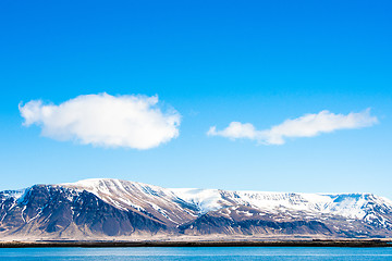 Image showing Mountains with snow by the ocean