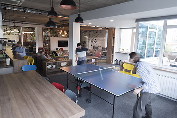Image showing playing ping pong tennis at creative office space