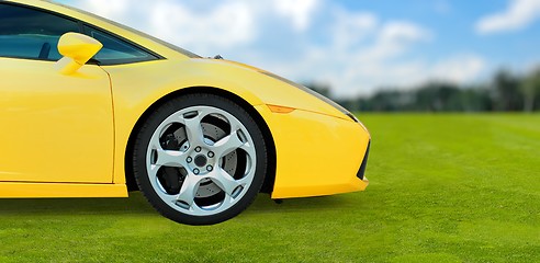 Image showing Yellow Luxury Sport Car outdoor on green grass