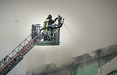 Image showing Firefighters in action fighting fire