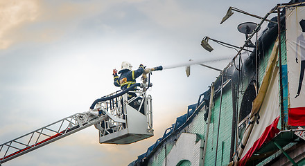 Image showing Firefighters in action fighting fire