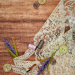 Image showing Lace and thread on wooden background