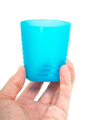 Image showing Empty blue plastic glass, held in a male persons hand