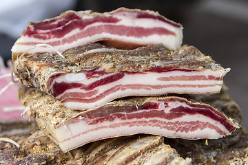 Image showing Pieces of smoked bacon on a street stand