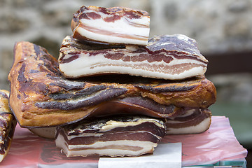 Image showing Pieces of smoked bacon on a street stand