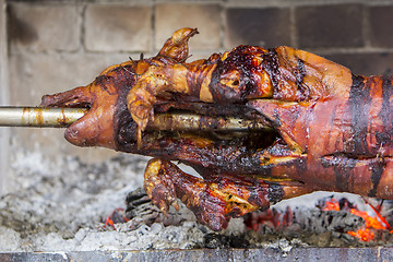 Image showing Roasting suckling pig on the broach