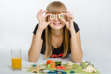 Image showing Young girl put roll your eyes and with a smile looks in the frame