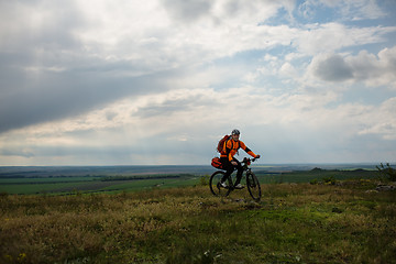 Image showing Young man is riding bicycle outside. Healthy Lifestyle.