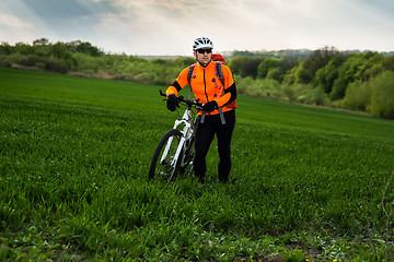 Image showing Young man is riding bicycle outside. Healthy Lifestyle.