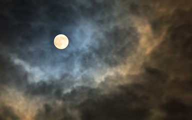 Image showing Mysterious midnight cloudy sky with full moon and moonlit clouds