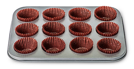 Image showing In front cupcake and muffin pan with paper cups