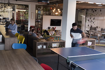 Image showing playing ping pong tennis at creative office space