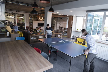 Image showing playing ping pong tennis at creative office space