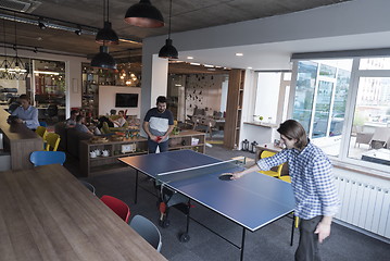 Image showing playing ping pong tennis at creative office space