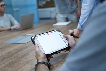 Image showing close up of businessman on meeting using tablet