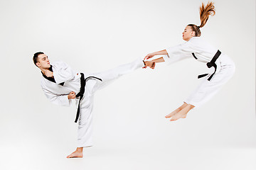 Image showing The karate girl and boy with black belts
