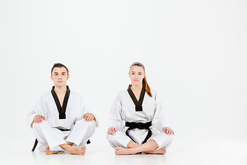 Image showing The karate girl and boy with black belts