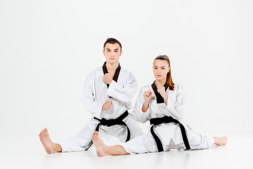 Image showing The karate girl and boy with black belts