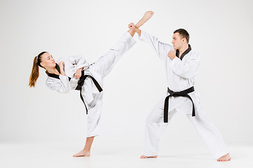 Image showing The karate girl and boy with black belts