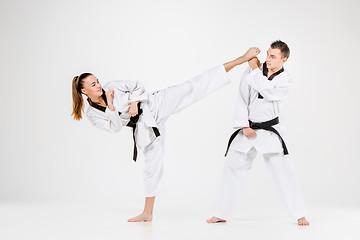 Image showing The karate girl and boy with black belts